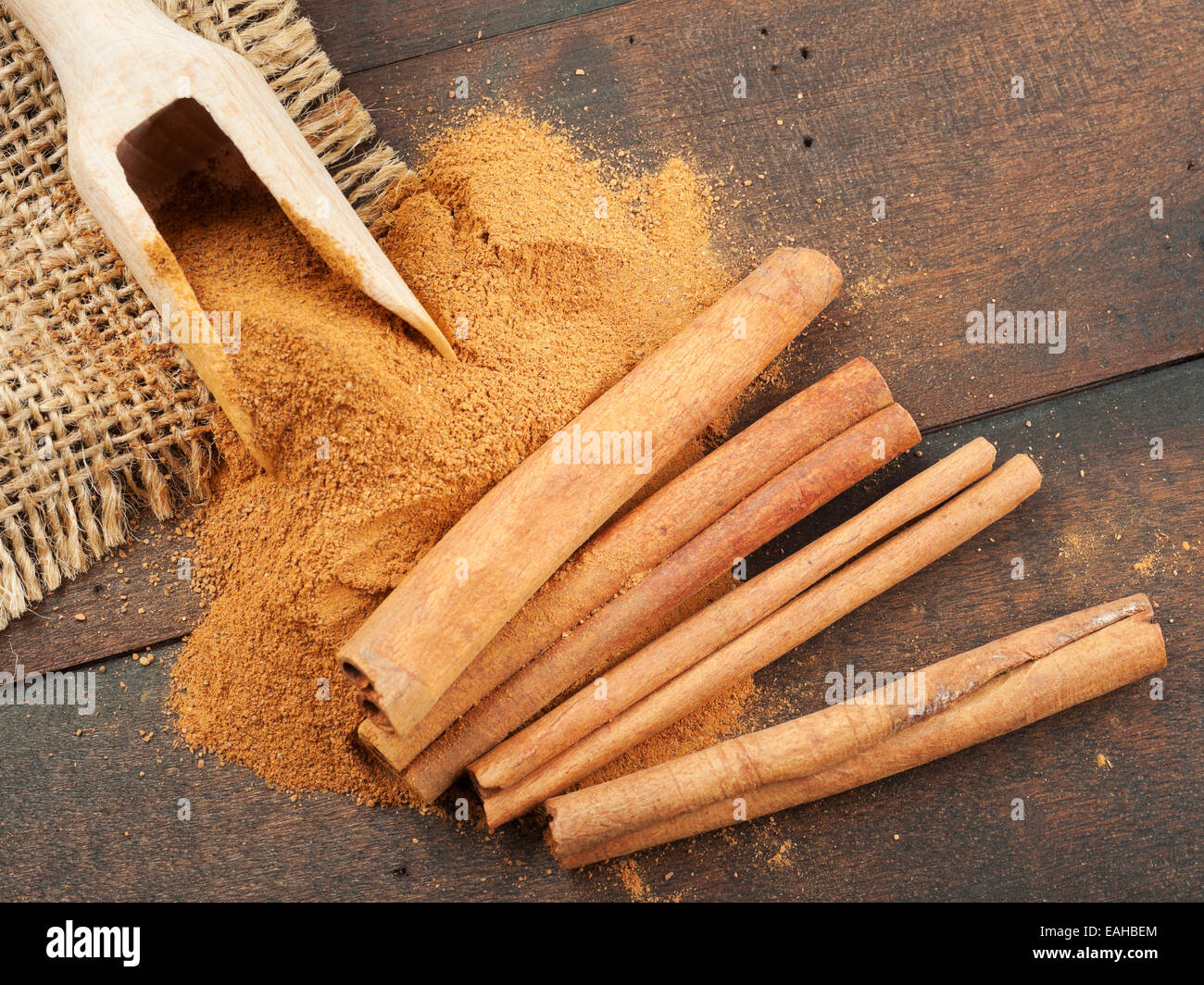 Zimtstangen und Zimtpulver in hölzerne Schaufel Stockfoto