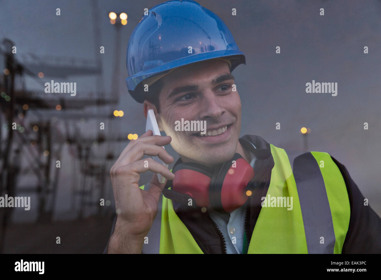 Arbeiter reden über Handy in der Nähe von Fenster Stockfoto
