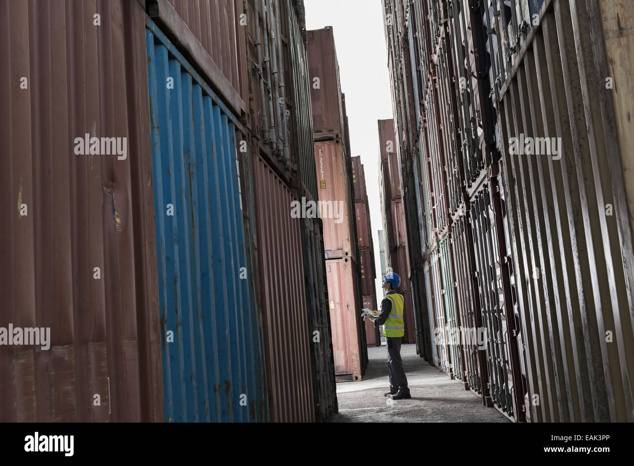 Arbeiter stehen zwischen Containern Stockfoto