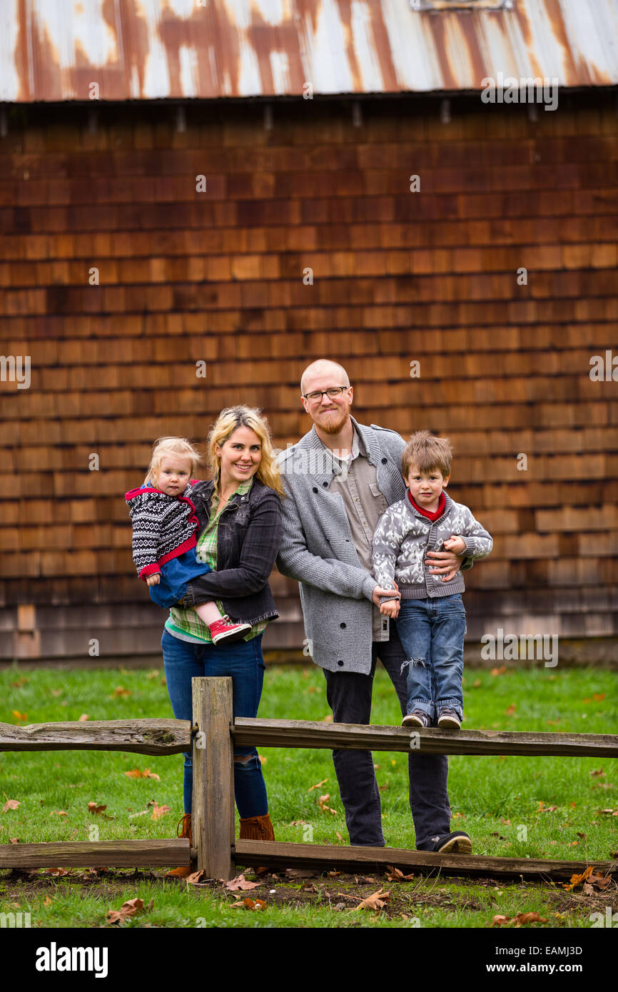 Familie Lifestyle Portrait von Mutter, Vater, Sohn und Tochter vor eine rustikale Scheune im Land. Stockfoto