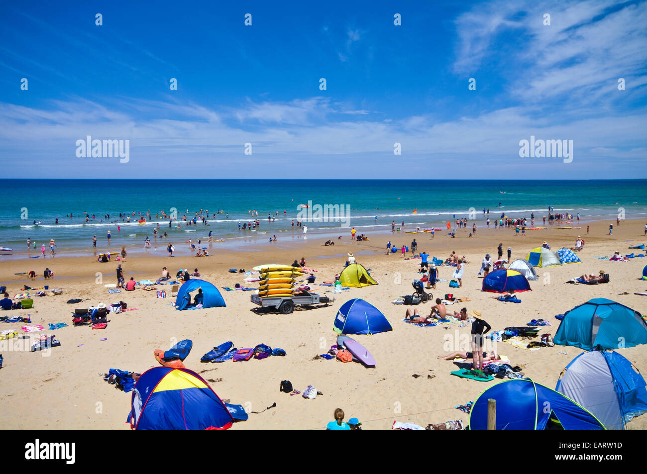 Strand-Kuppeln, Surfbretter und Familien an einem überfüllten Strand im Sommer. Stockfoto