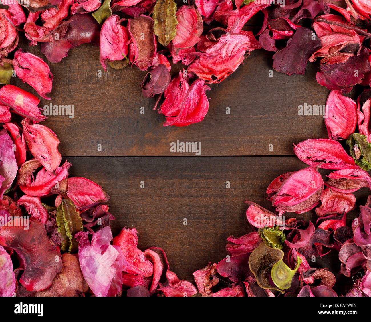 Blütenblätter bilden eine Herzform Holz Hintergrund Stockfoto