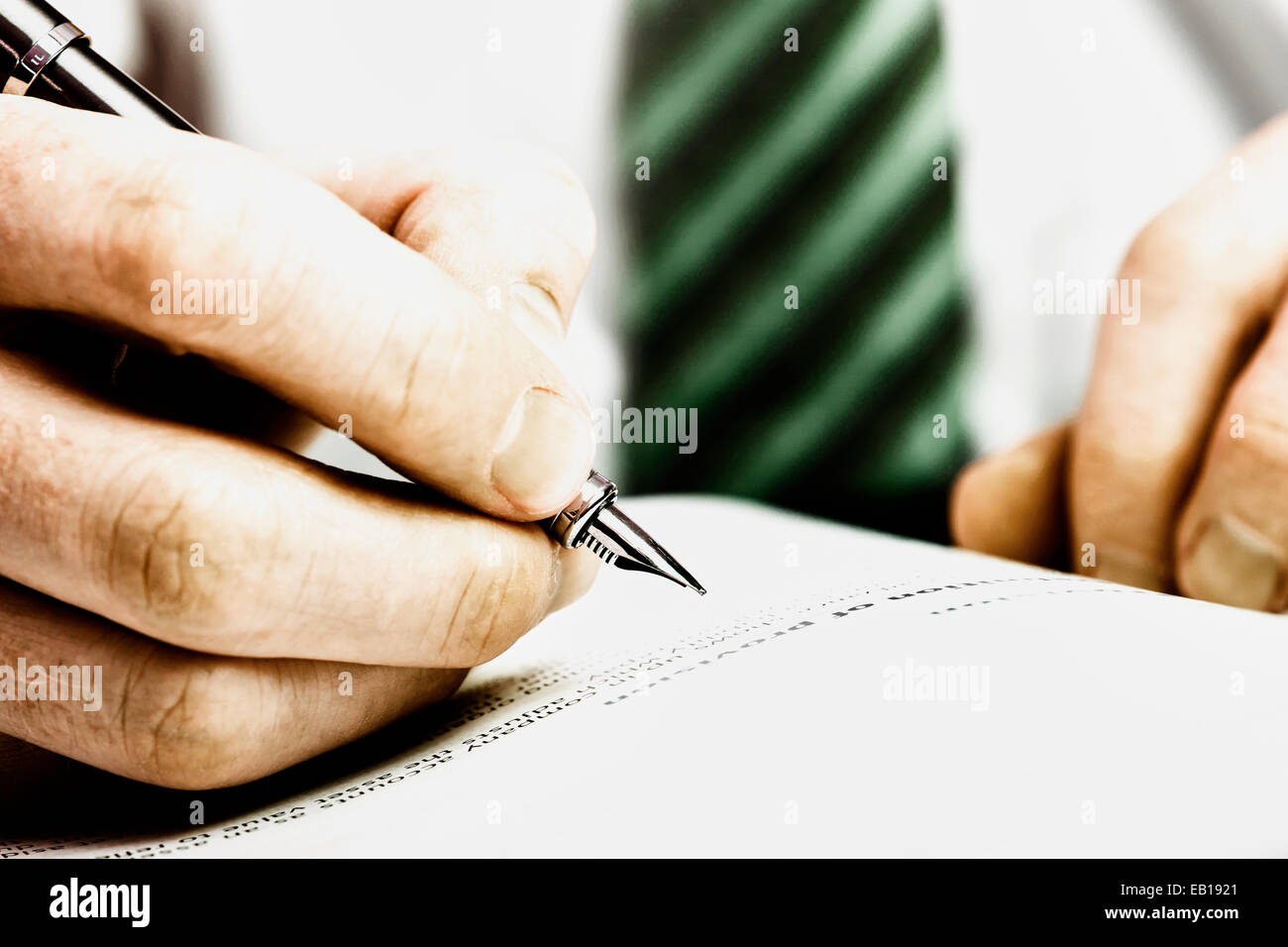 Eine Hand mit einem Füllfederhalter und etwa Schriftsteller eine Notiz oder markieren Sie einen Text zur Korrektur. Stockfoto