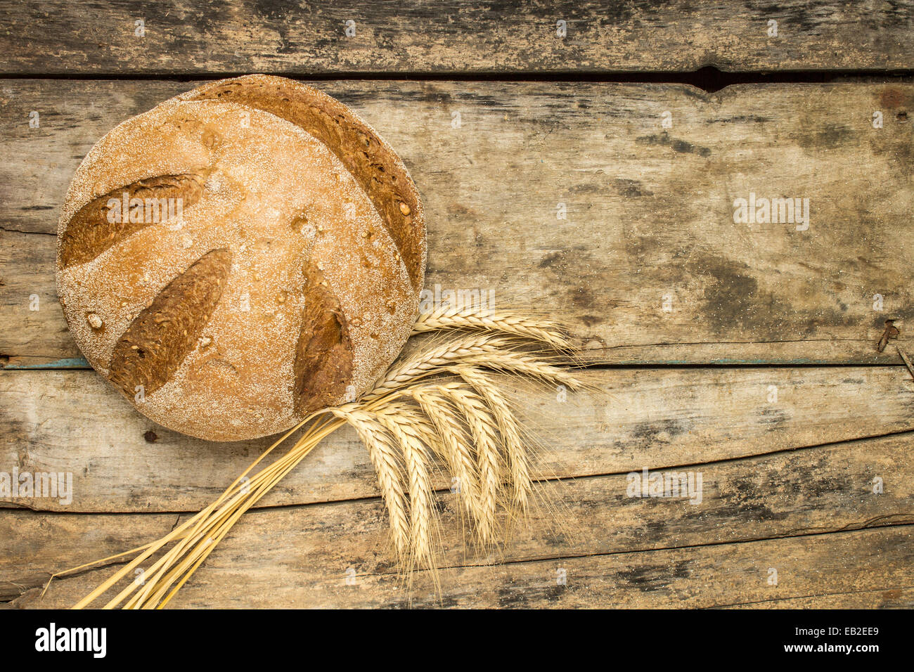 Laib Brot mit Ähren auf Holz Hintergrund Stockfoto