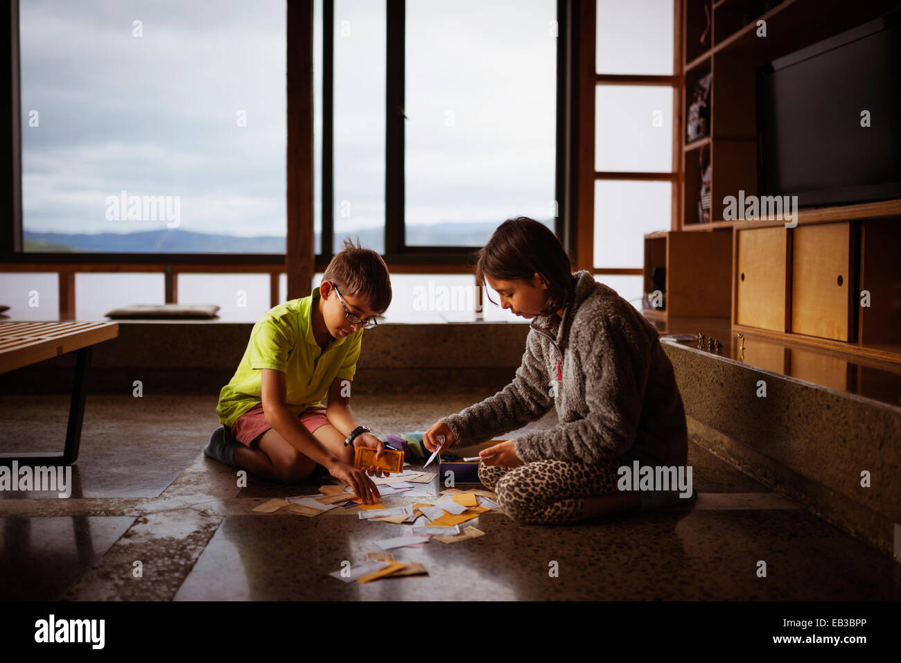 Mischlinge Kinder spielen gemeinsam am Boden des Wohnzimmers Stockfoto
