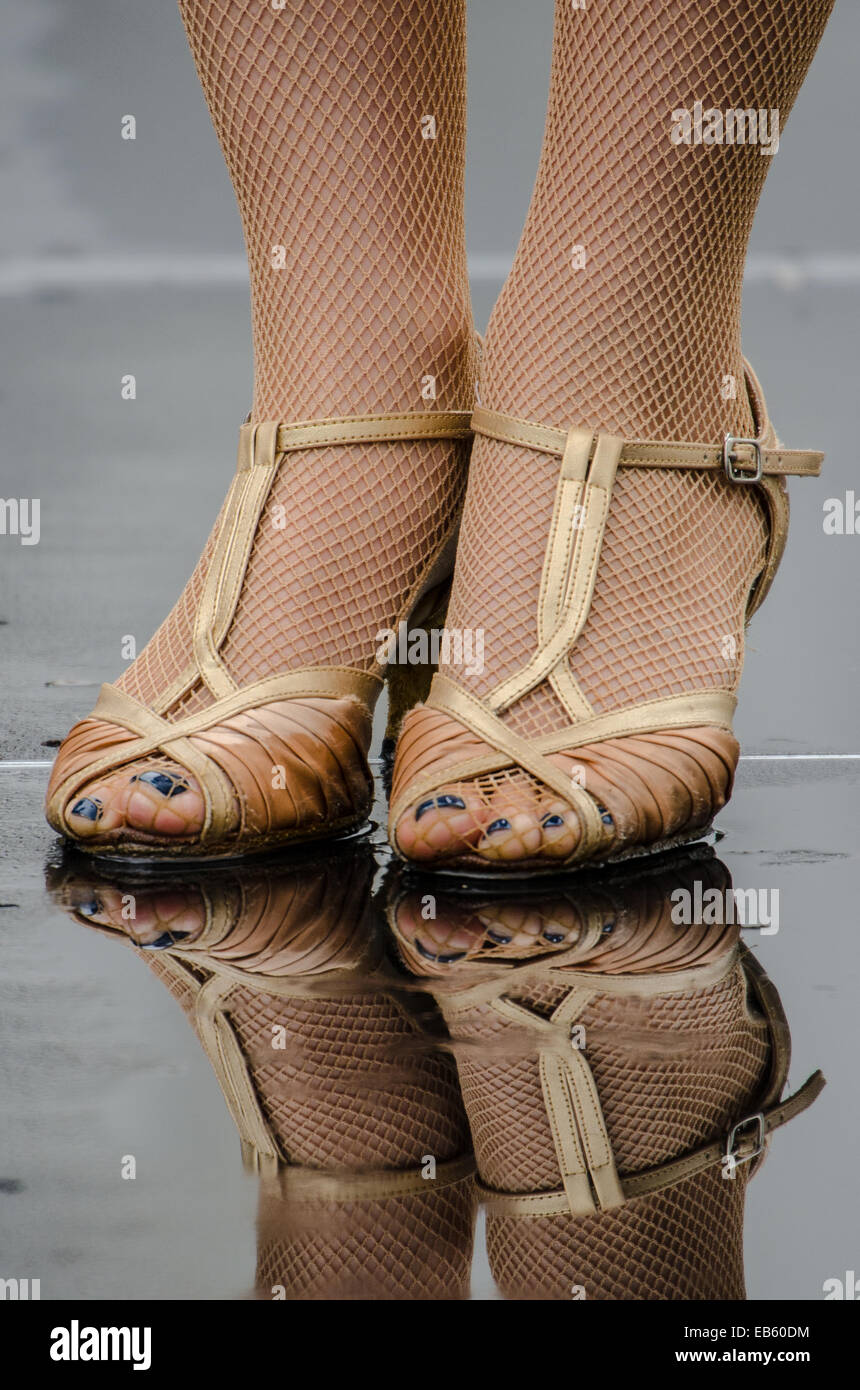High Heels im Regen. Weibchen mit netzstrumpfhose und Riemchen Schuhe auf  einem nassen regnerischen Tag. Reflexion Stockfotografie - Alamy