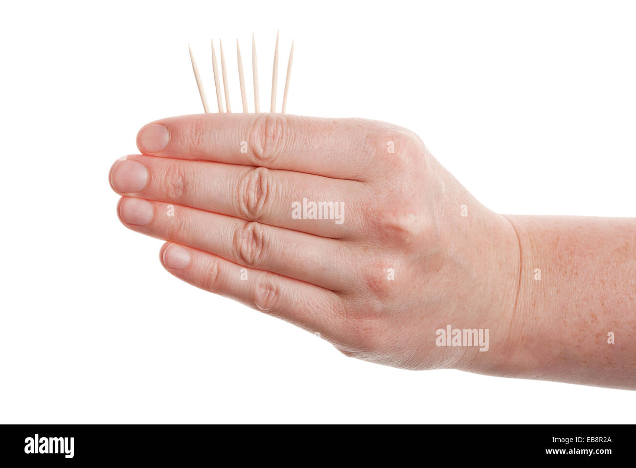 Zahnstocher in Hand isoliert auf weißem Hintergrund Stockfoto