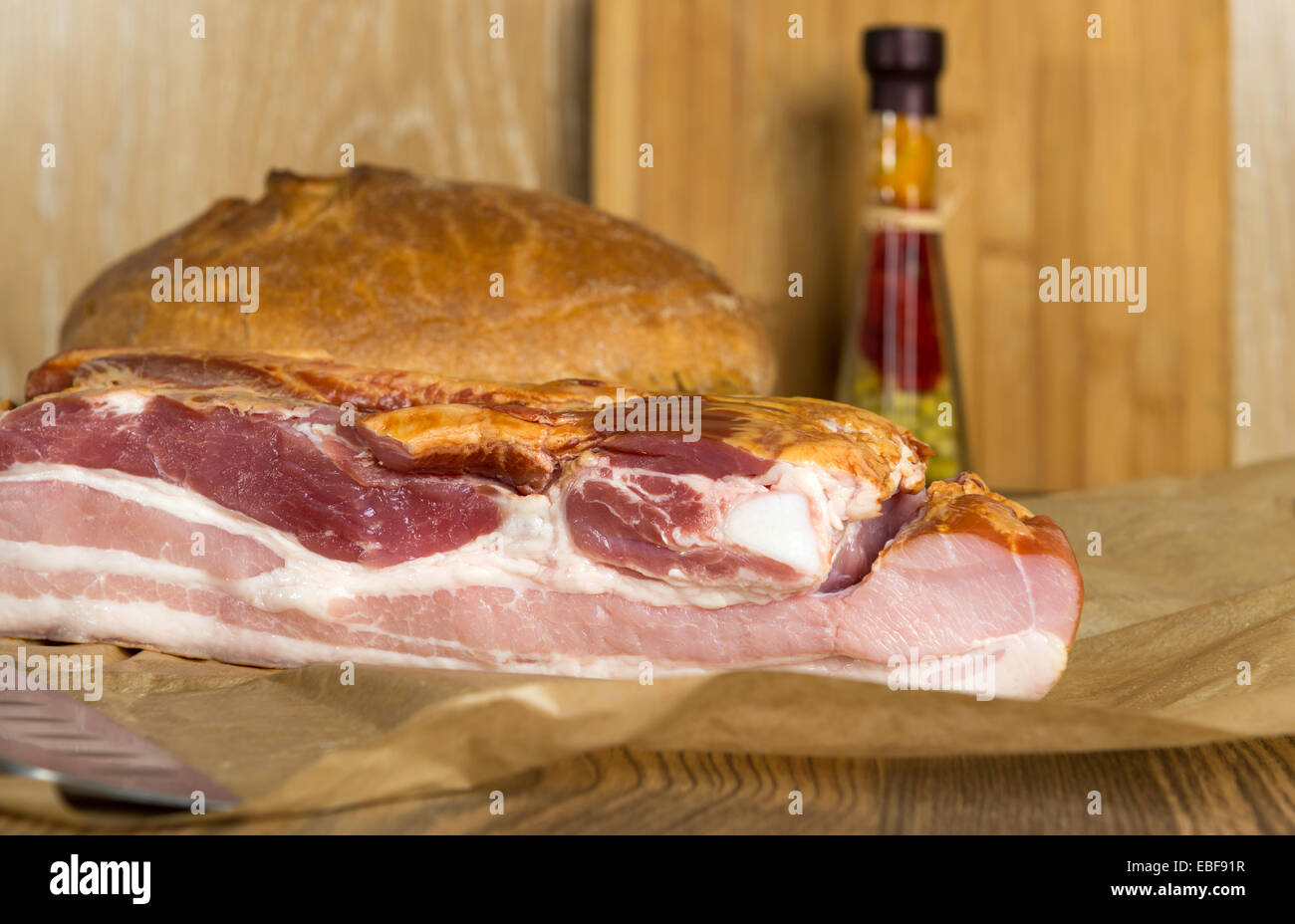 geräuchertem Schweinebauch - Speck und Brot auf dem Tisch Stockfoto