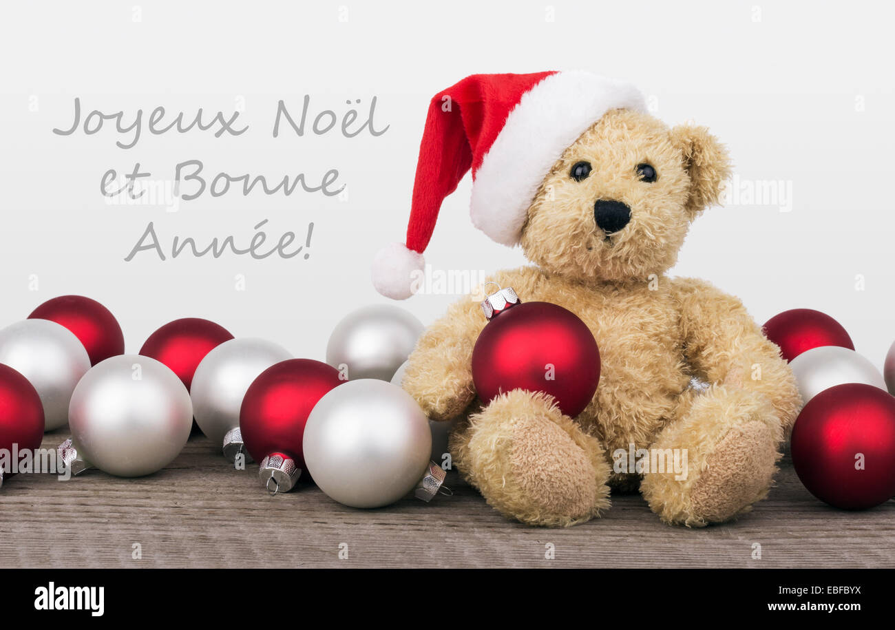 Französisch Weihnachtskarte mit Teddybär und Text Frohe Weihnachten und ein glückliches neues Jahr Stockfoto