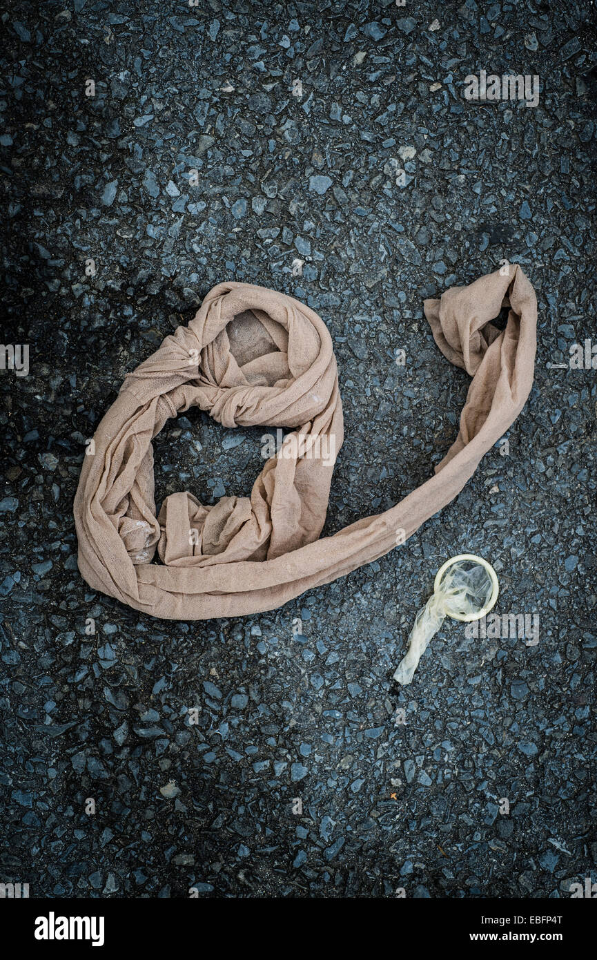 Lässige saferSex ein gebrauchtes Kondom und eine ausrangierte Strumpfhosen auf dem Boden, UK