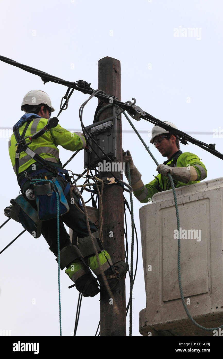 Zwei macht Versorgungsmaterial Arbeiter elektrische Kabel zu ersetzen. Stockfoto