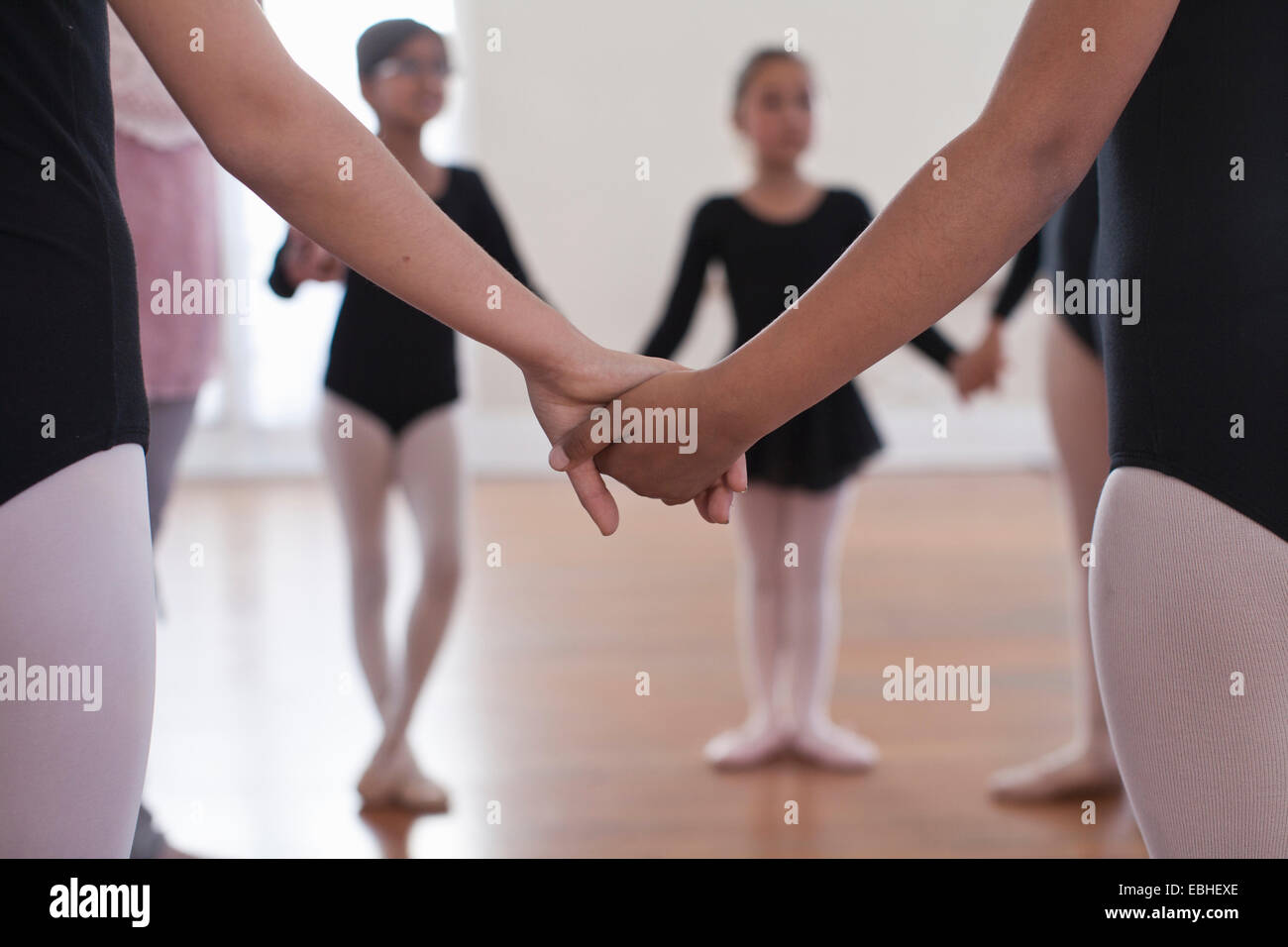 Rückansicht einer Gruppe von Ballett Schulmädchen Hand in Hand Stockfoto