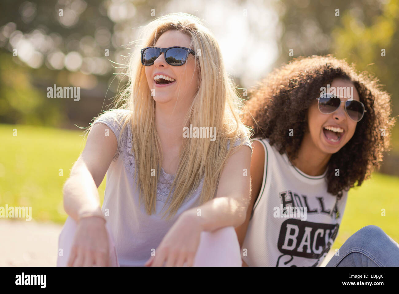 Zwei junge Freundinnen lachen im park Stockfoto