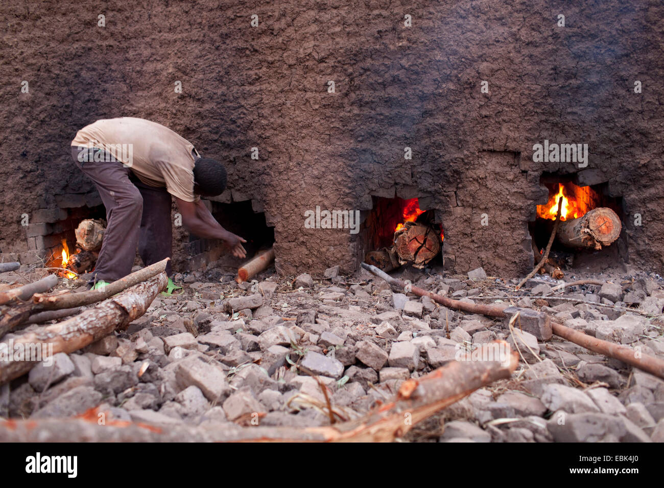 Arbeitnehmer, die einen traditionellen Ofen Heizung, für Trocknung Ton, Burundi, Karuzi, Buhiga Ziegel Stockfoto