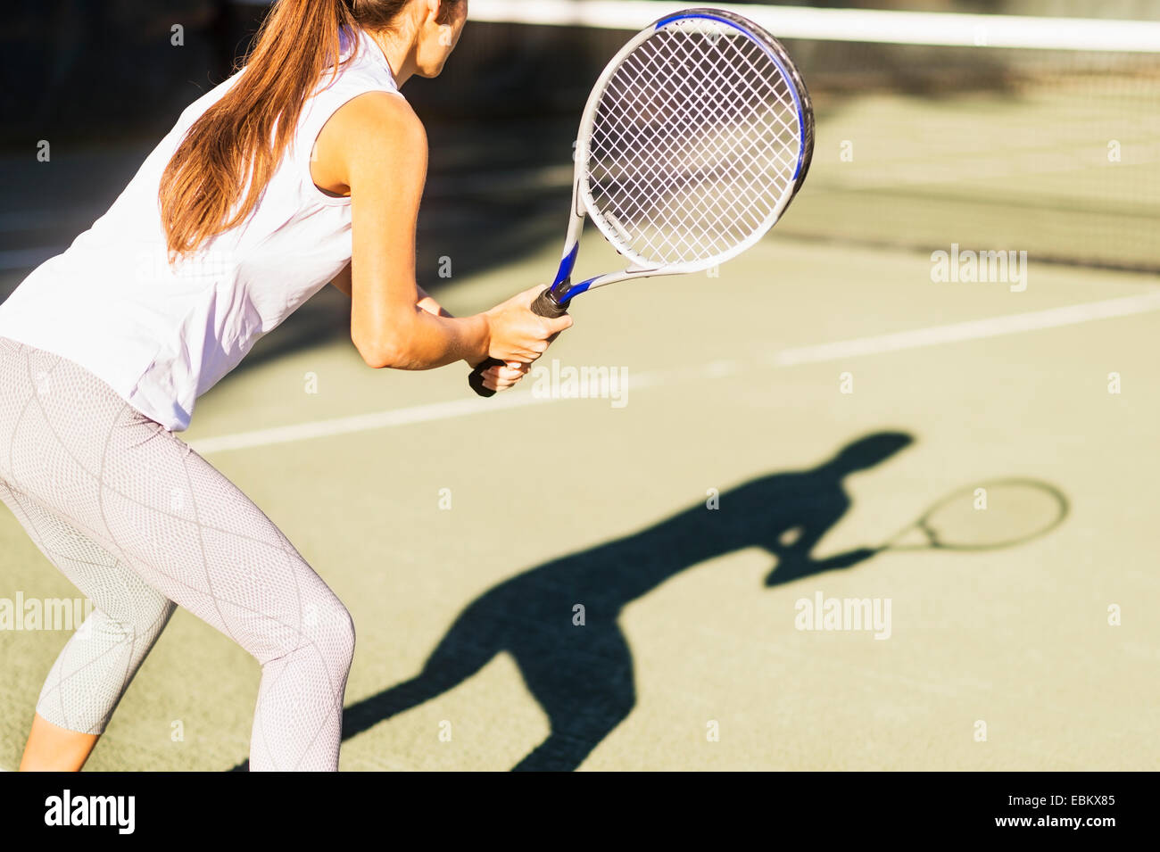 Hoch-Abschnitt Schuss der jungen Frau, die mit dem Tennisspielen im Freibad Stockfoto