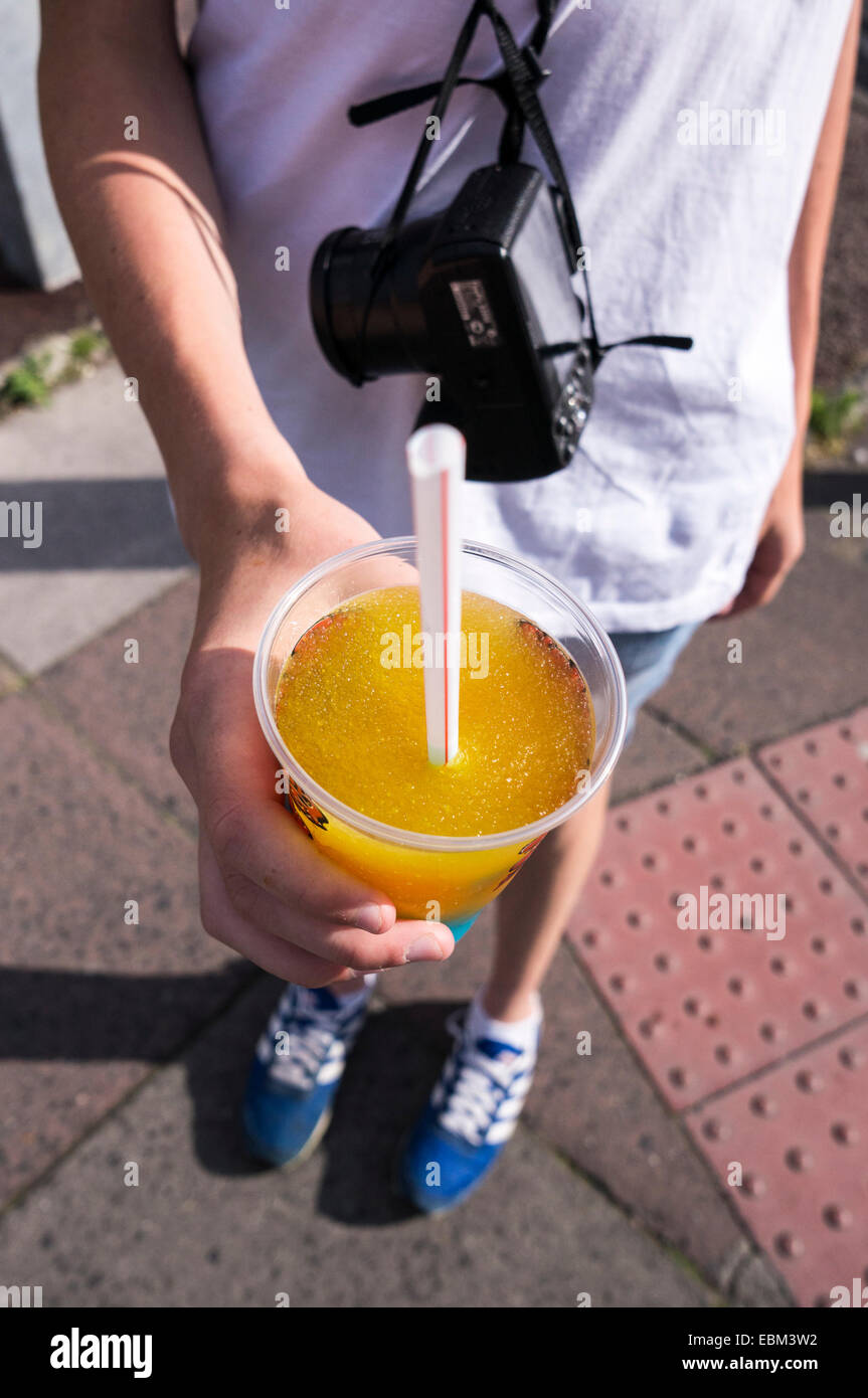 Hand, die matschigen kalte Frucht trinken mit Strohhalm trinken Stockfoto