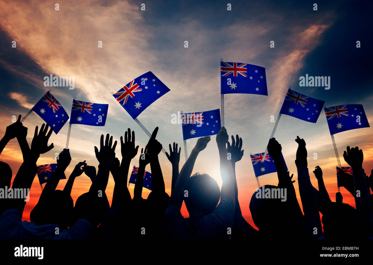 Gruppe von Menschen schwenkten australische Fahnen im Gegenlicht Stockfoto