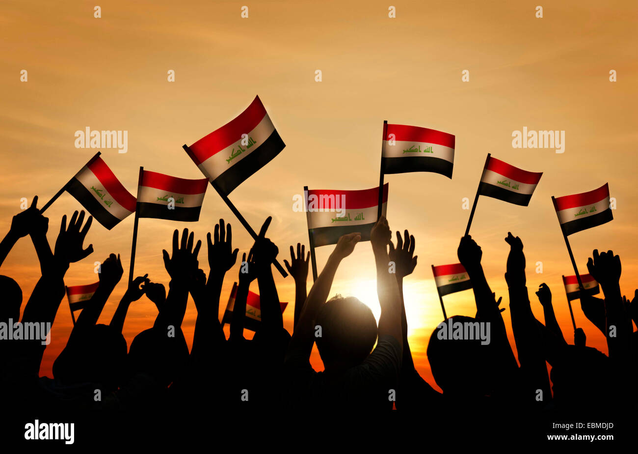 Silhouetten von Menschen, die wehende Flagge des Irak Stockfoto