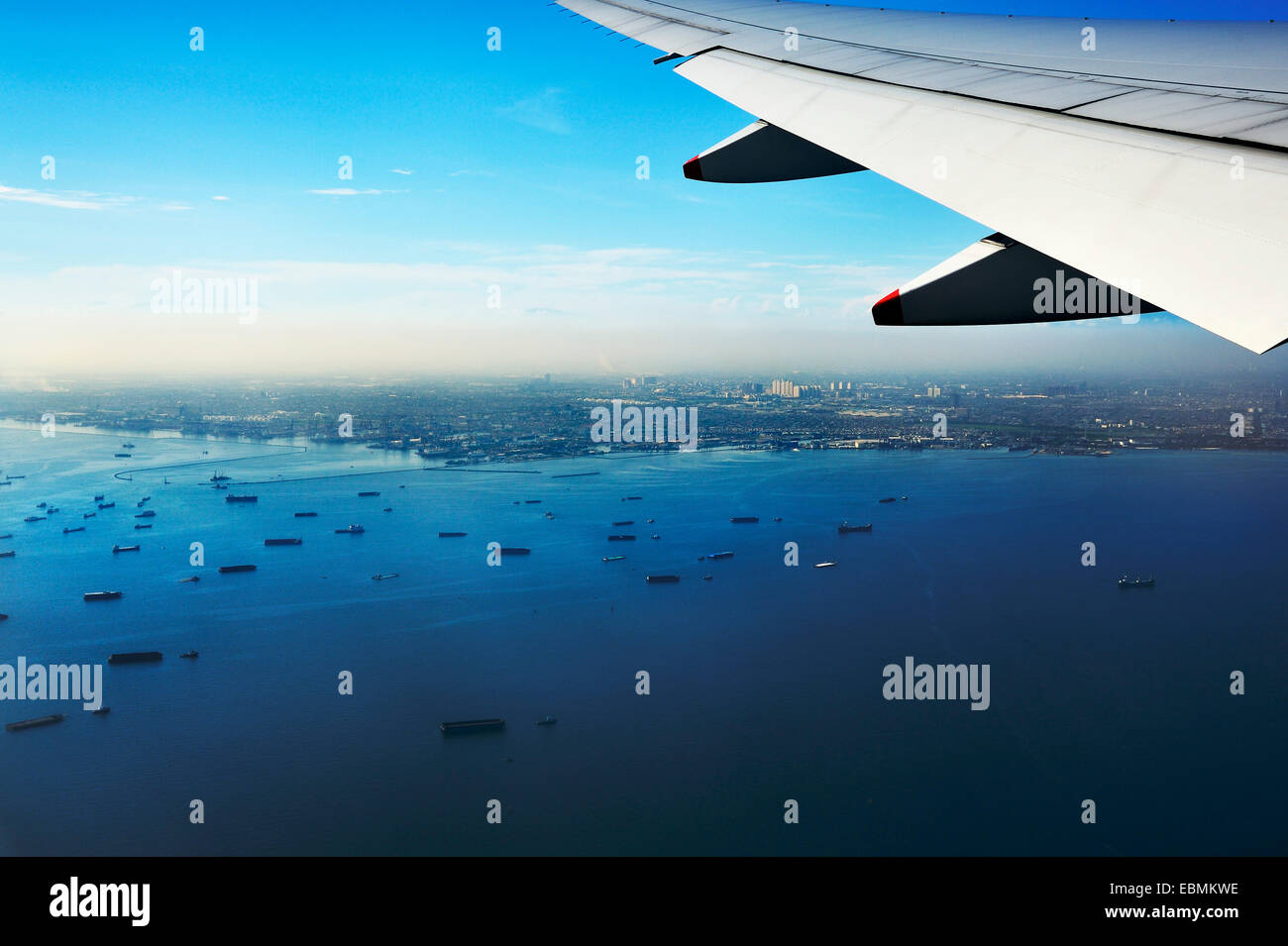 Flügel einer Ebene und Blick auf den Hafen von Jakarta auf der Zielseite Ansatz, in der Nähe von Jakarta, Java, Indonesien Stockfoto