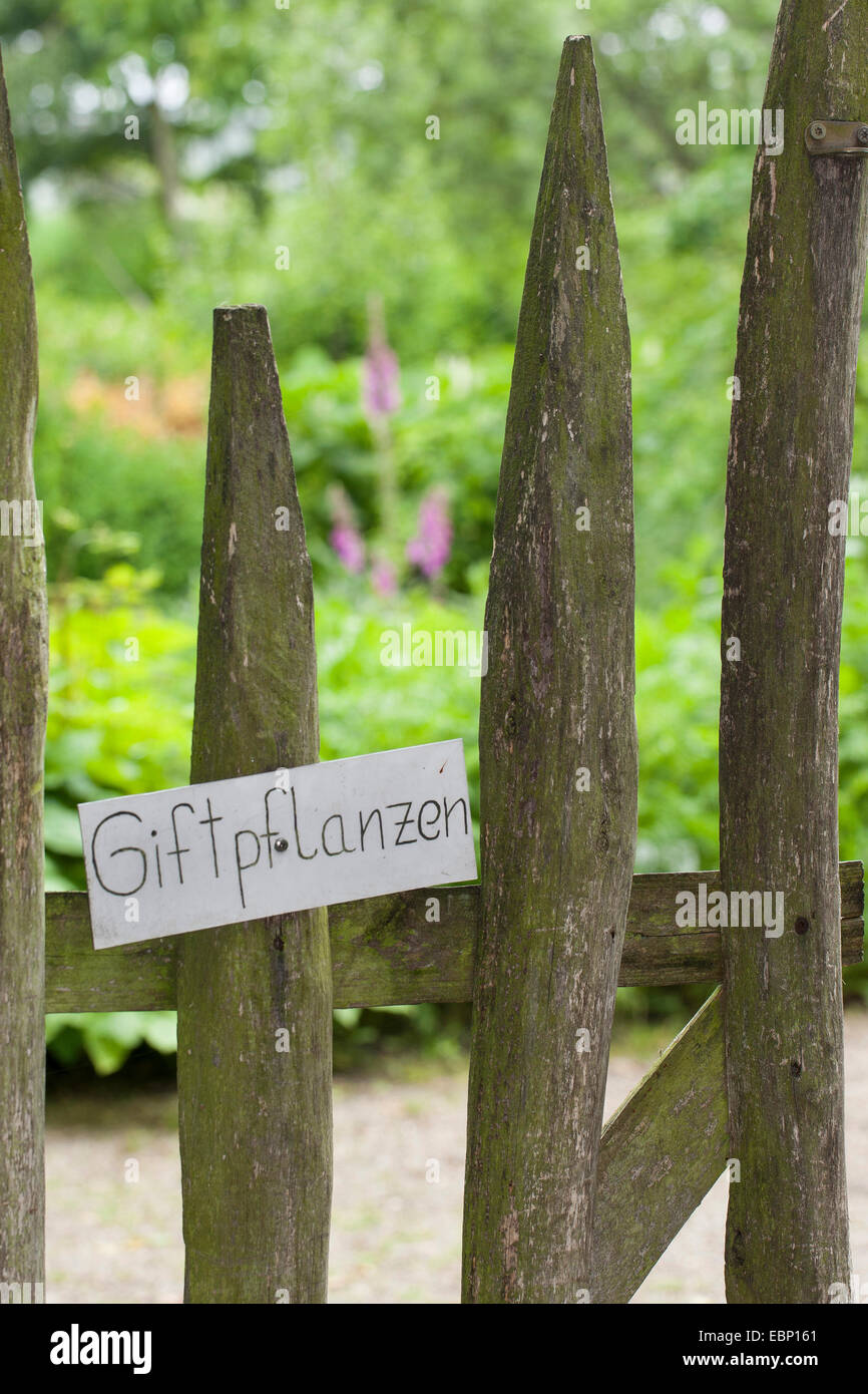 Schild am Eingang eines Gartens mit Pflanzen können Stockfoto