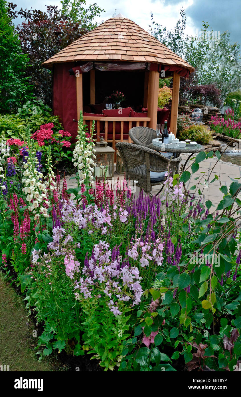 Die Terrasse in einem reflektierenden Wasser Garten mit bunten Blumen Stockfoto