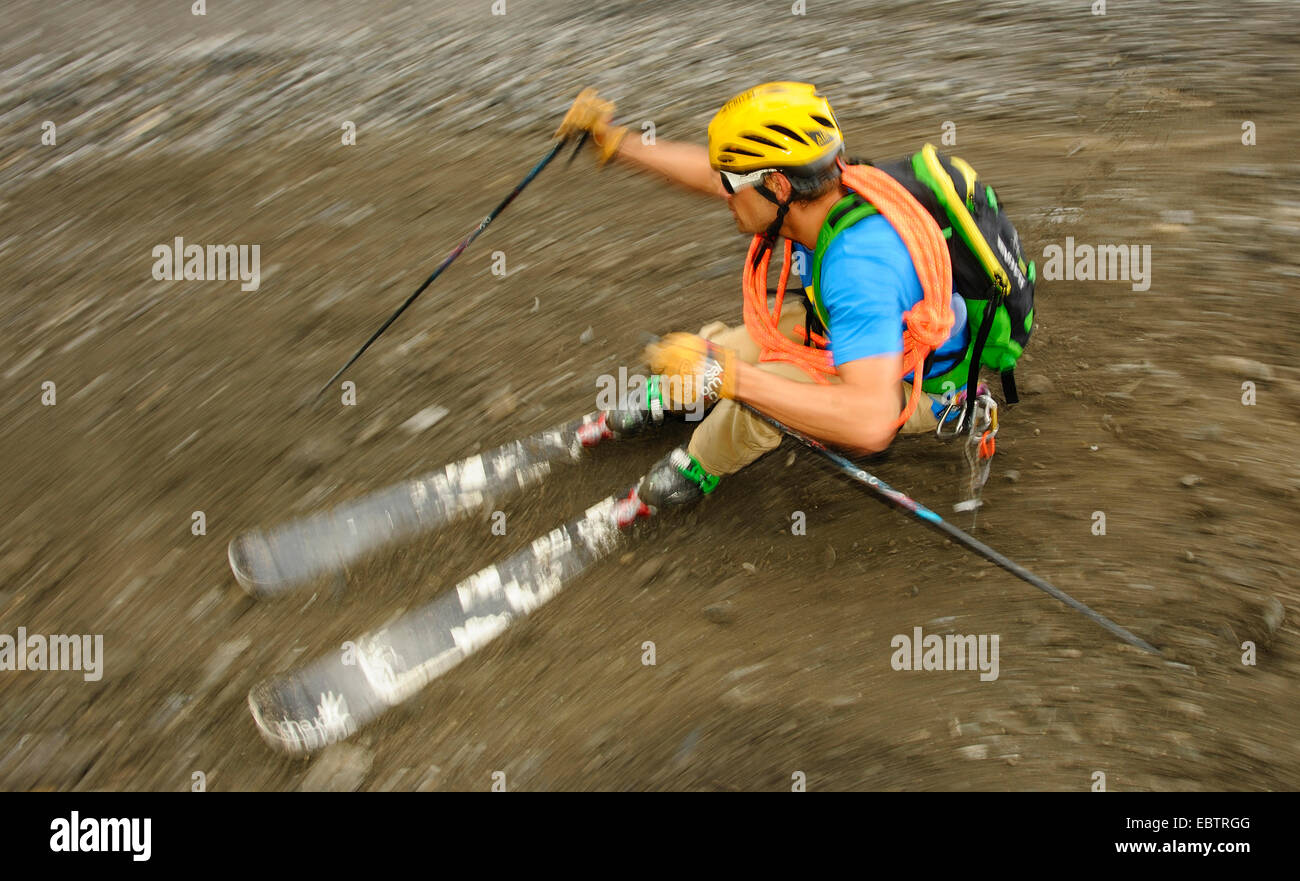 Freeride-Skifahrer auf felsigen Hang bergab Stockfoto