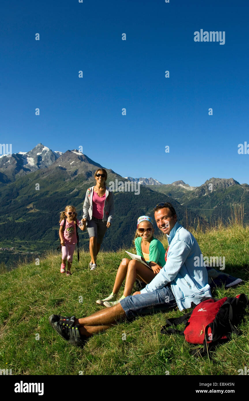 Familie auf einem Bergweg, Mädchen auf der Suche durch ein Feld Glas, Frankreich Stockfoto