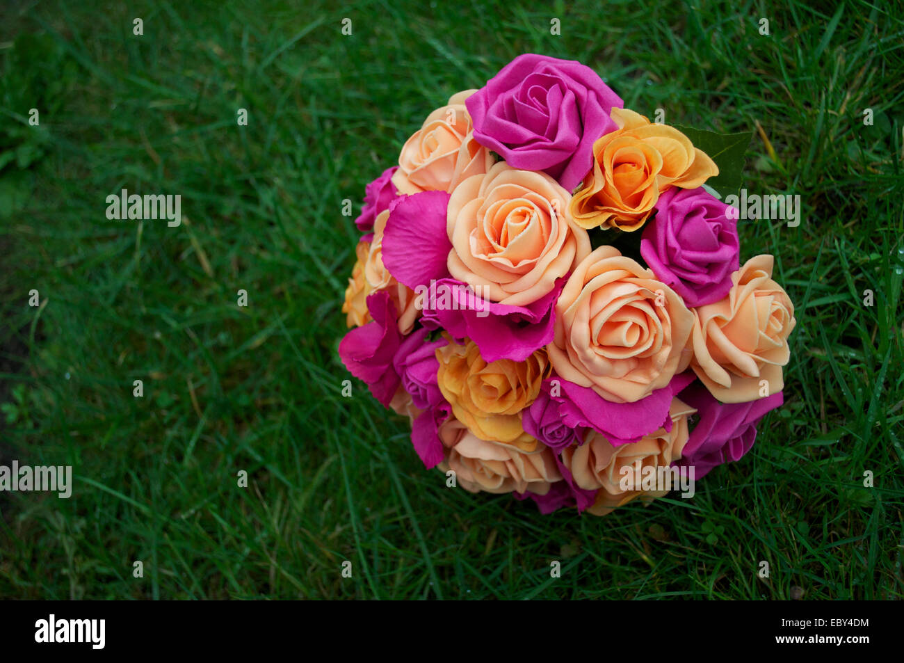 Rosa, Pfirsich und orange Braut Blumen vor dem Hintergrund der grünen Rasen. Stockfoto