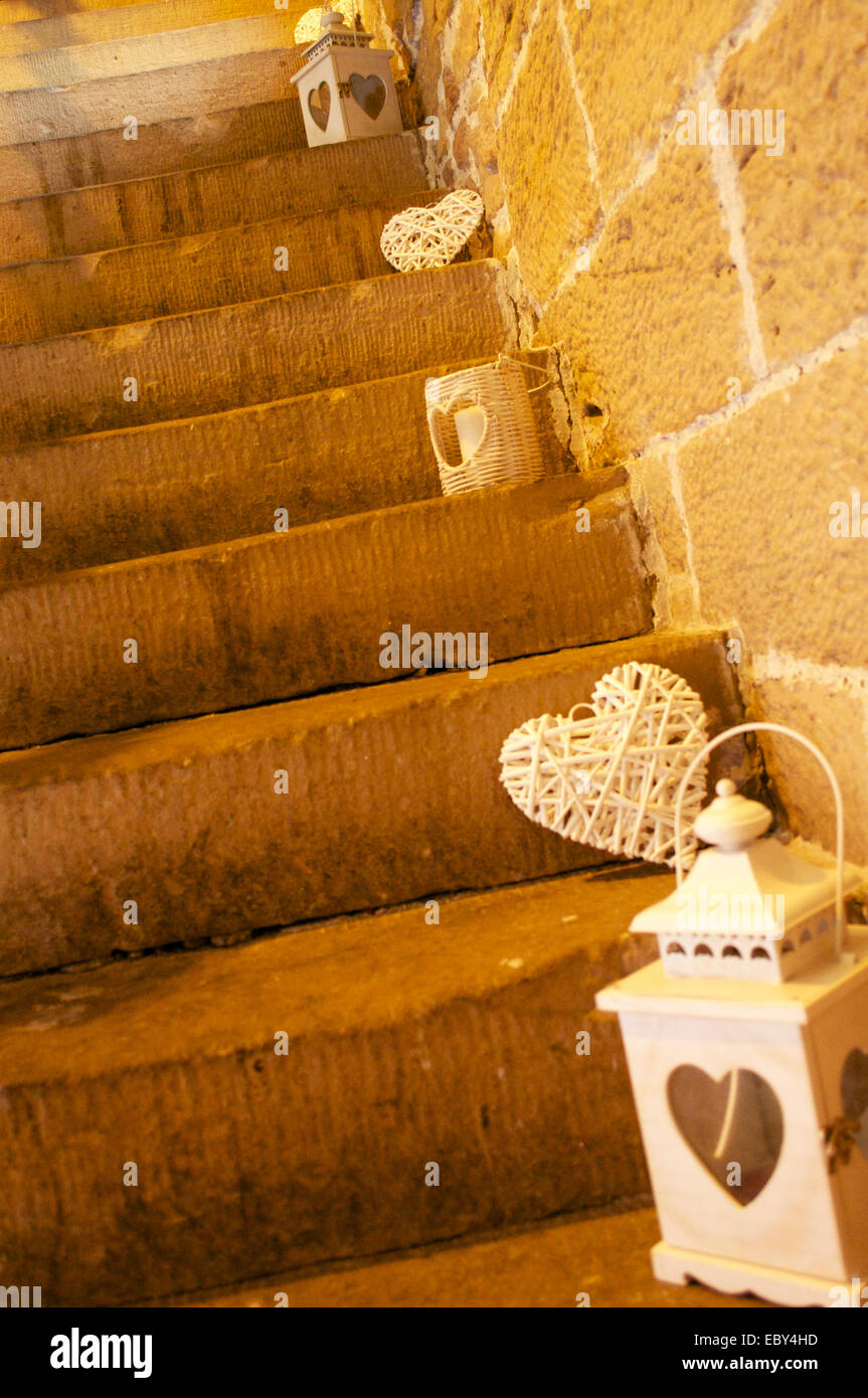Wicker Herzen und Laternen auf steinernen Stufen. Stockfoto