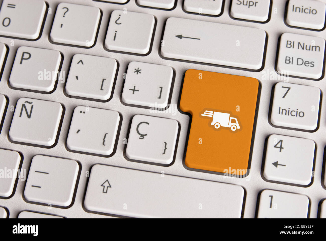 Spanische Tastatur mit Lieferung Versand Lastwagen-Symbol über Schaltfläche "Goldgrund". Bild mit Beschneidungspfad für einfachen Wechsel der Schlüssel Stockfoto