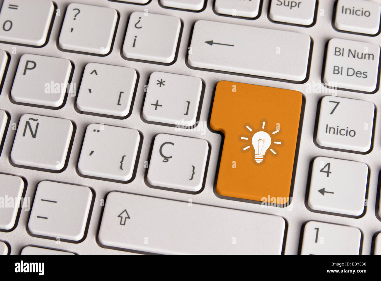 Spanische Tastatur mit neuen Idee Glühbirnen-Symbol über Schaltfläche "Goldgrund". Bild mit Beschneidungspfad für einfache Änderung der wichtigsten col Stockfoto