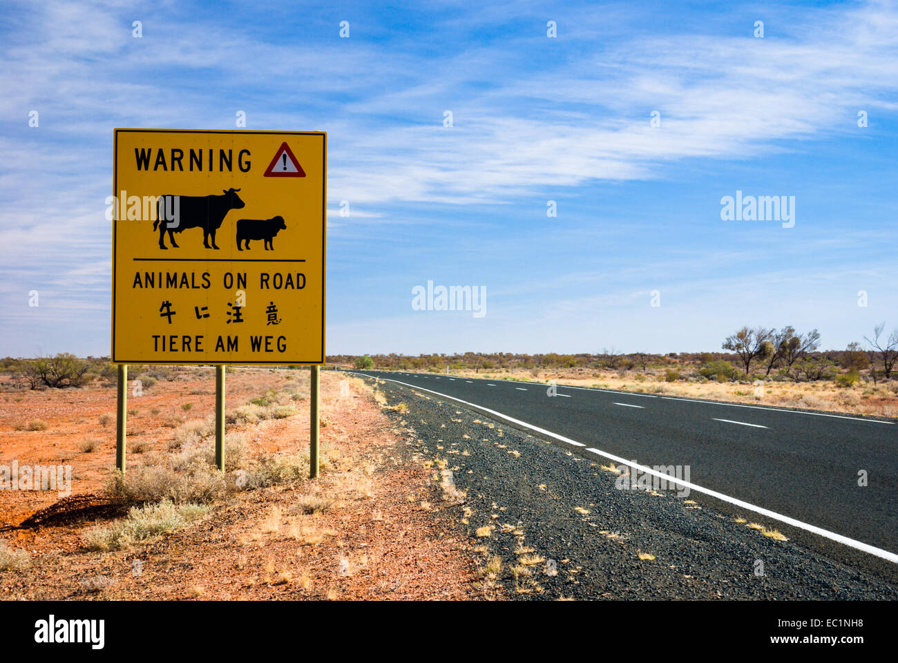 Tiere auf der Straße Warnung zu unterzeichnen, in drei Sprachen neben Autobahn im Outback Australien Stockfoto