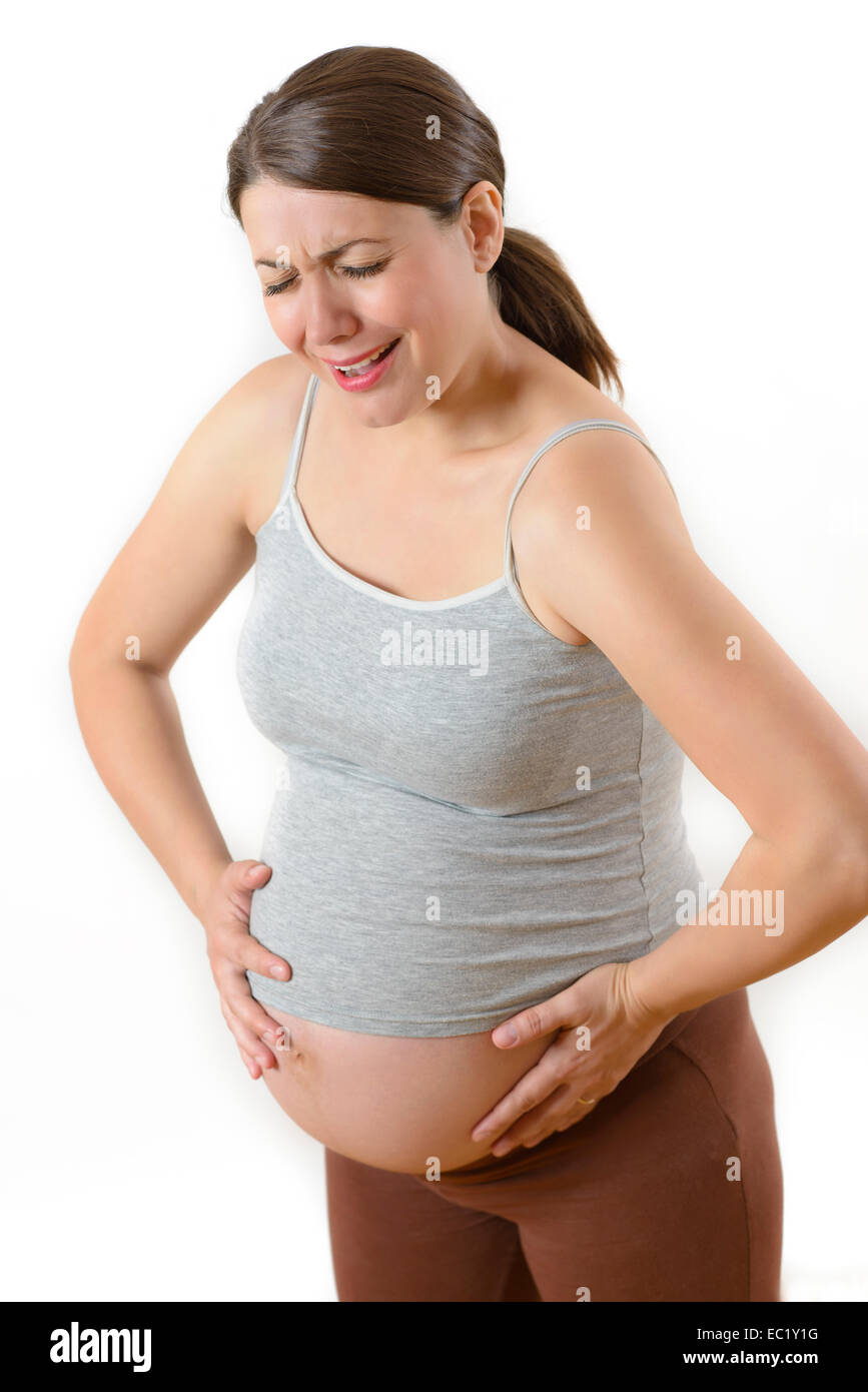 Schwangere Frau vor Schmerzen isoliert auf weiss Stockfoto