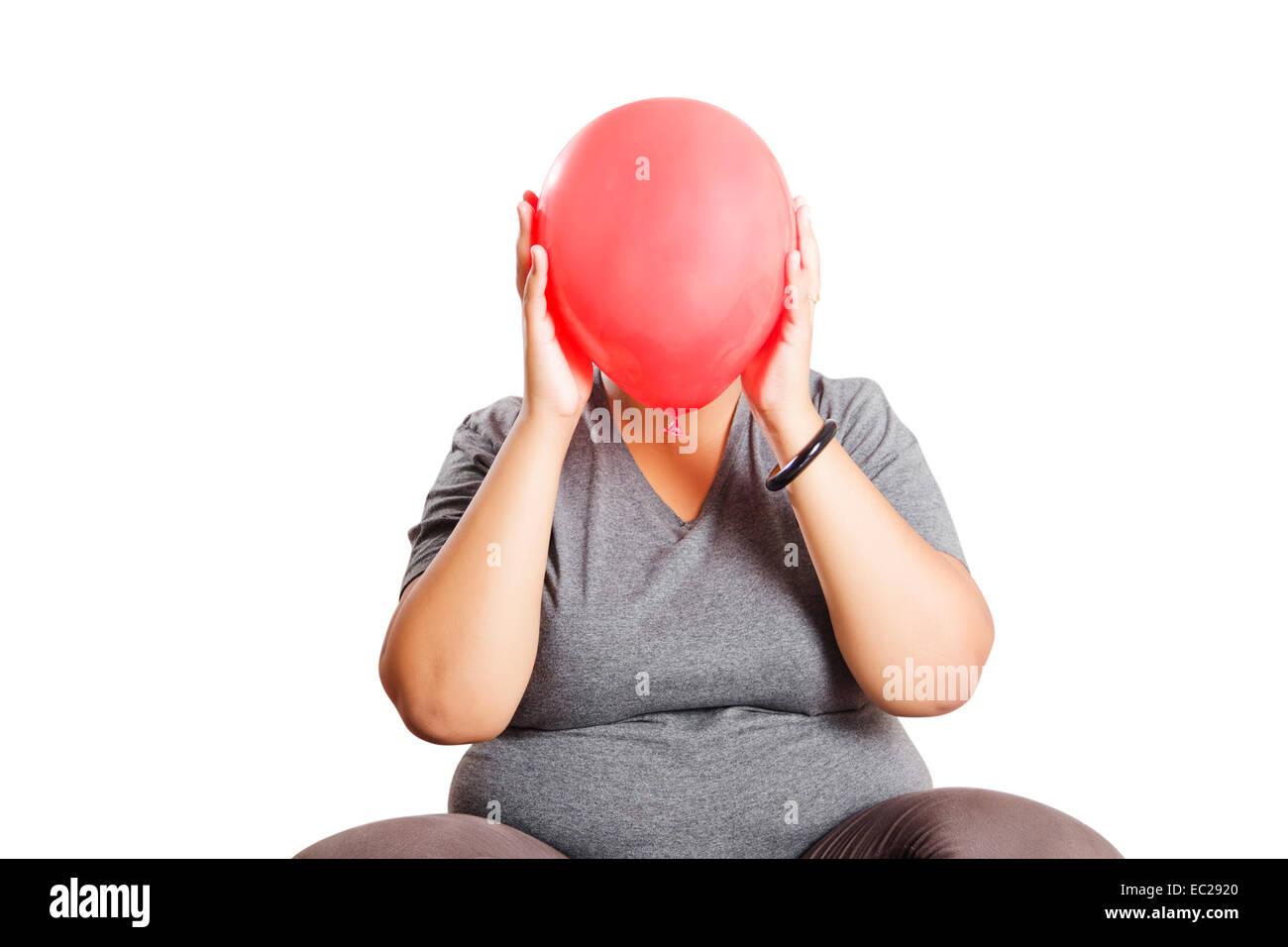 indische übergewichtige Dame versteckt Ballon Stockfoto