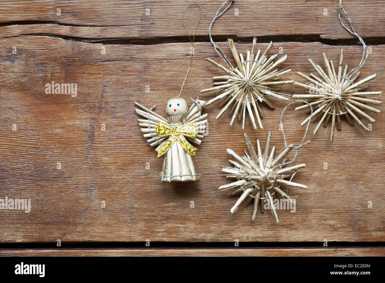 Vintage Spielzeug Engel Figur auf verwitterten Holztisch mit Stroh Schneeflocken Stockfoto
