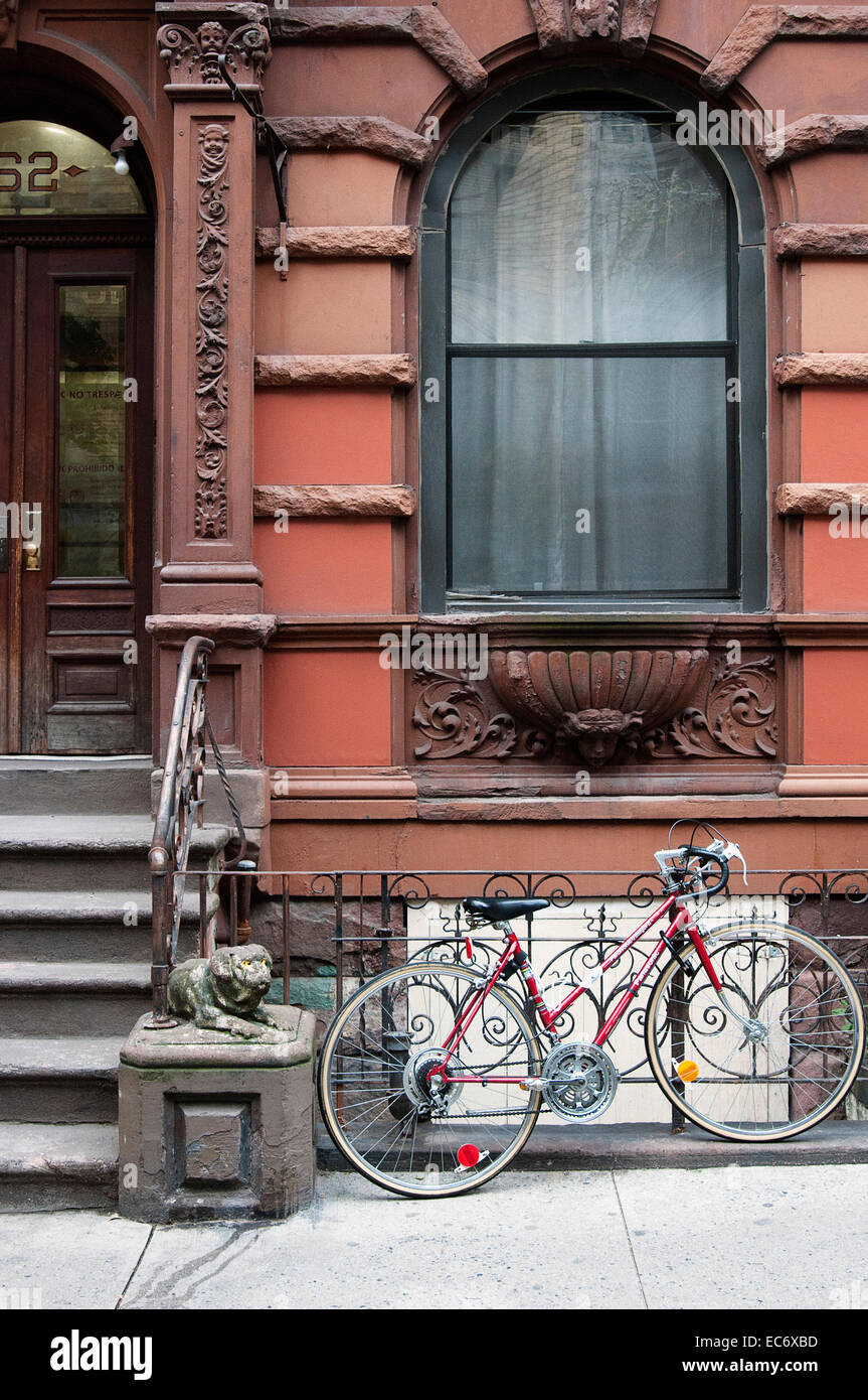 Ein Fahrrad eingesperrt an einen Zaun in New York City. Stockfoto