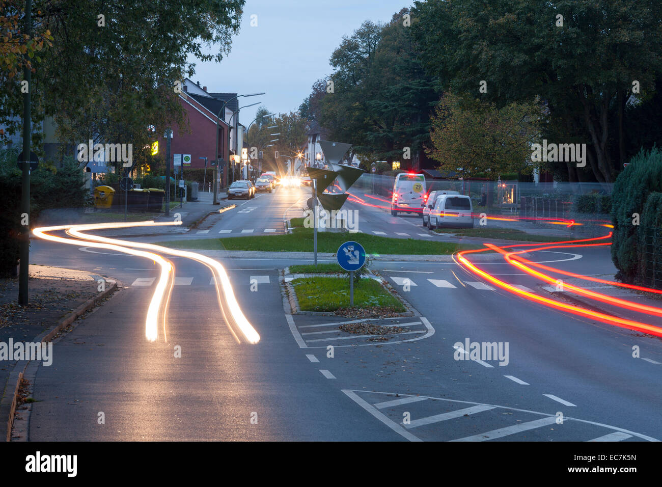 Deutschland, Nordrhein-Westfalen, Kamen, Kreisverkehr und Straße Verkehr am Abend Stockfoto