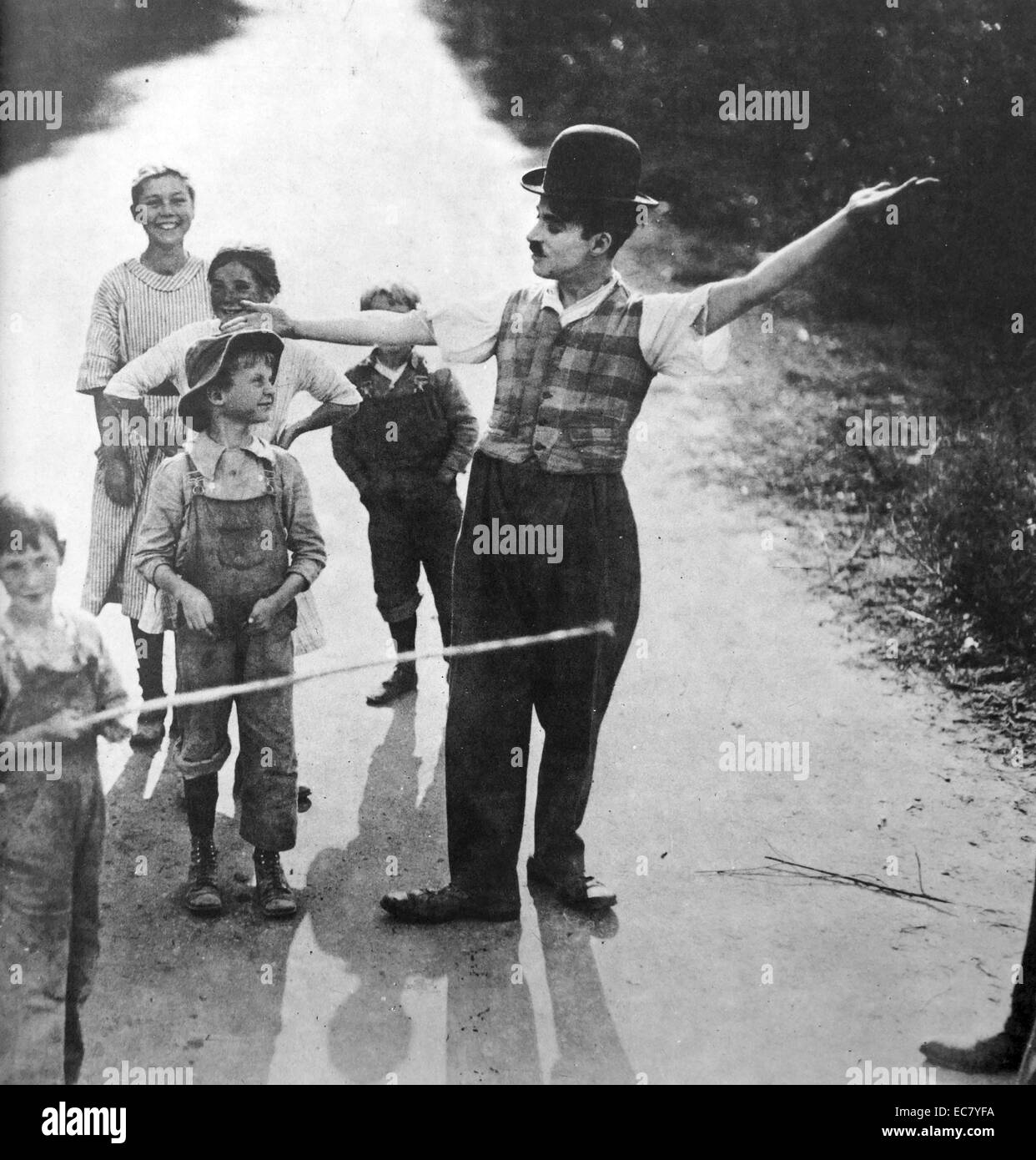 Charlie Chaplin mit einer Gruppe von Kindern. Stockfoto