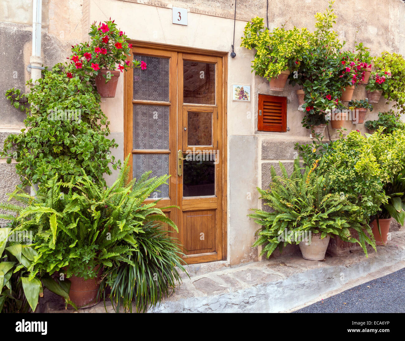 Eingang, umgeben von Blumen und Topfpflanzen, Valldemossa, Mallorca, Balearen, Spanien Stockfoto