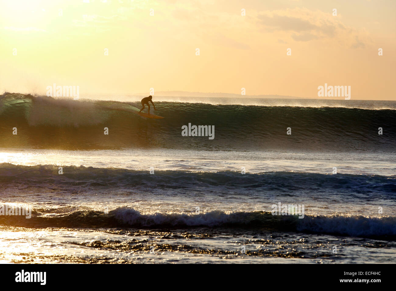 Surfen eine Welle bei Sonnenuntergang am Nembrala auf Rote Insel, Indonesien Stockfoto