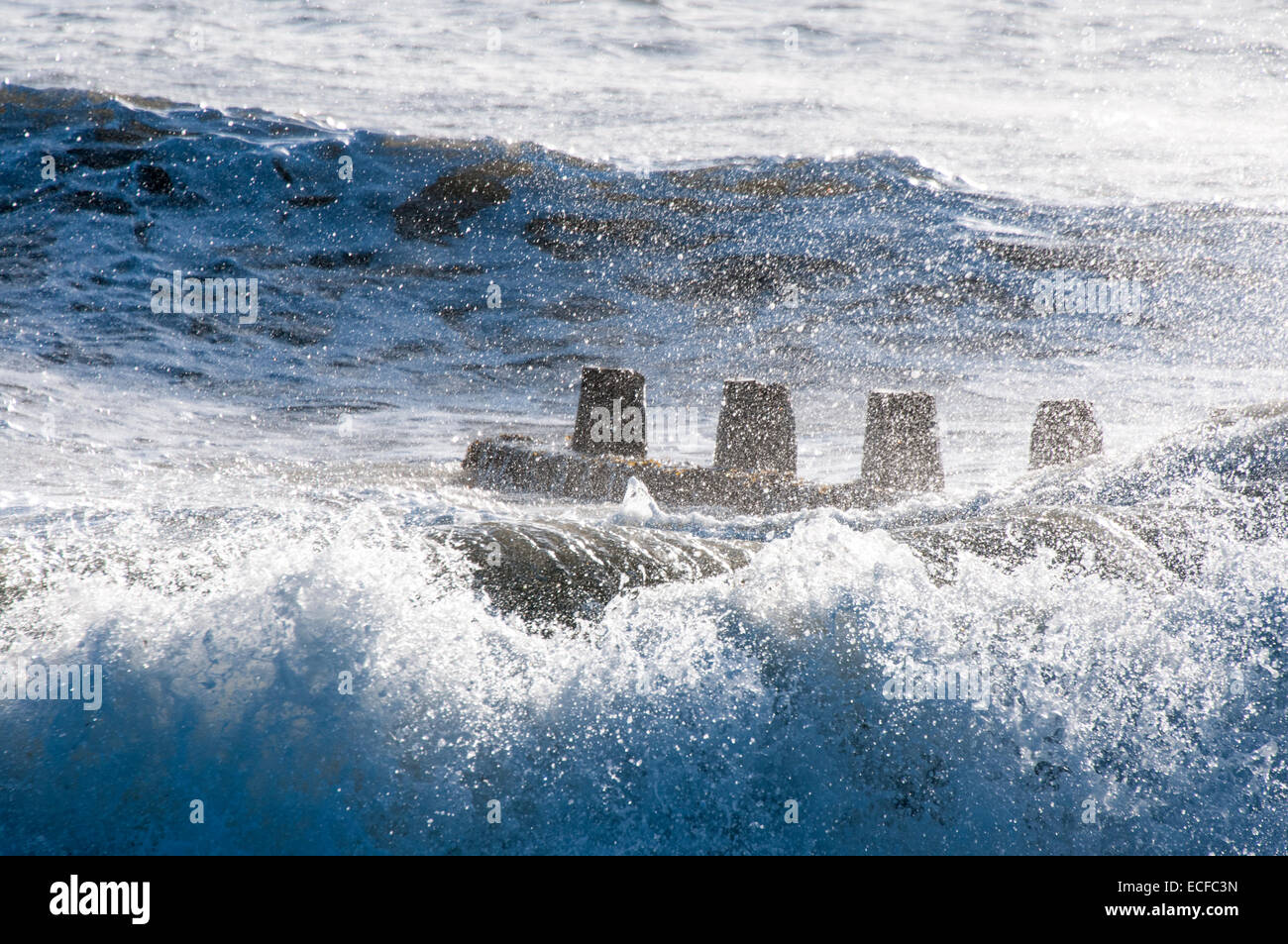 Wellen schlagen eine Buhne am Weststrand, Littlehampton, West Sussex Stockfoto