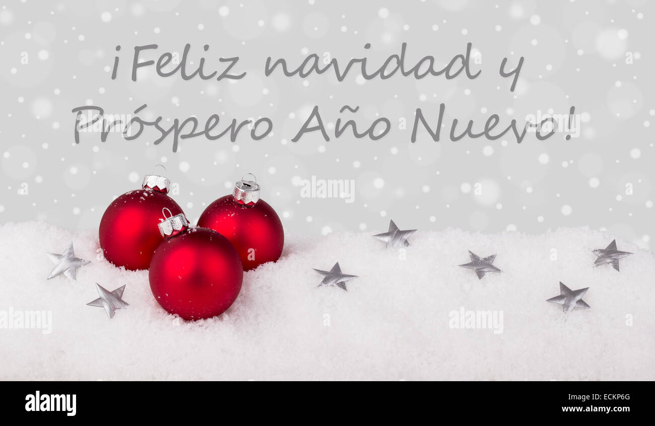 spanische Weihnachtskarte mit rote Christbaumkugeln Stockfoto