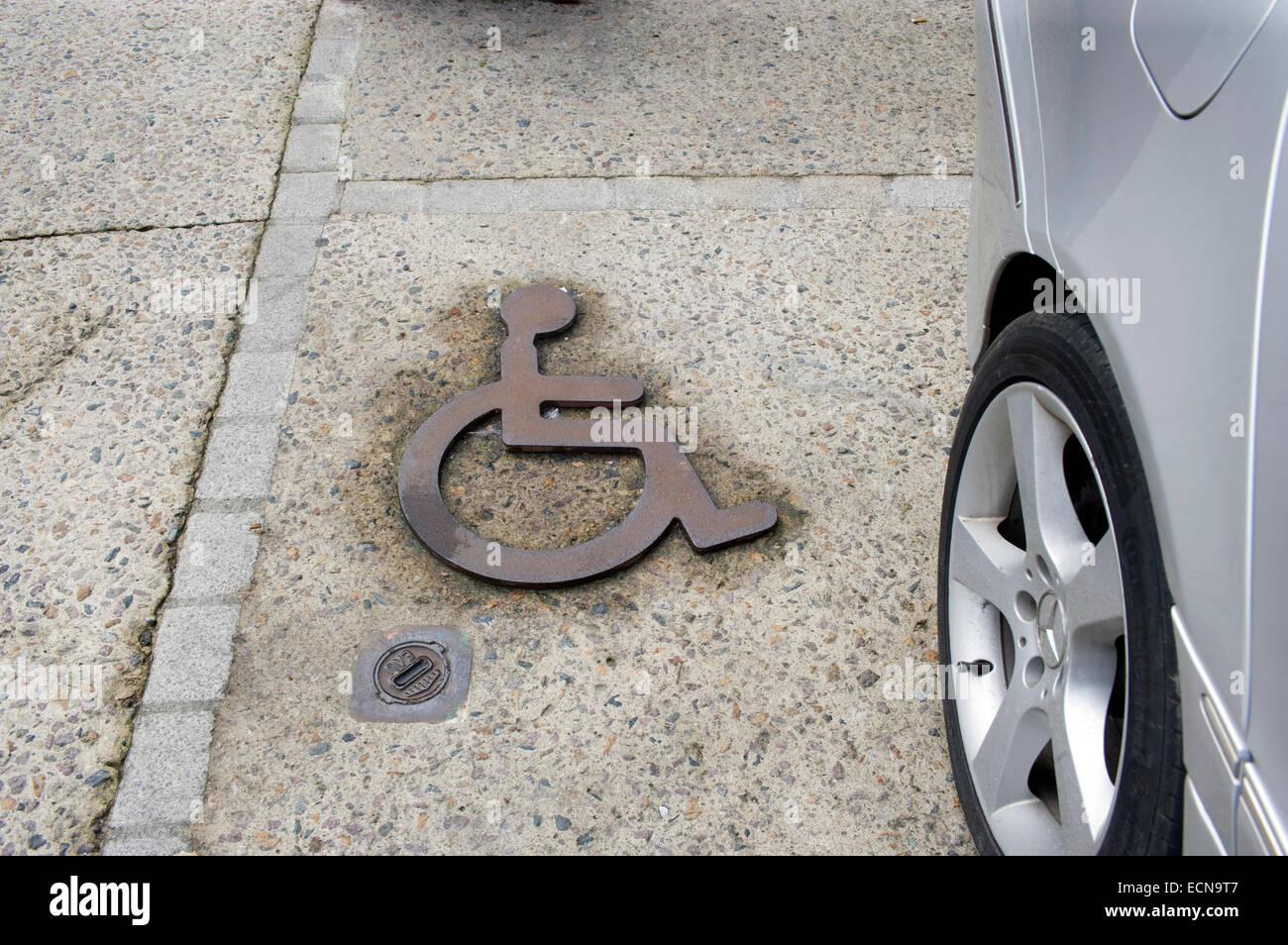 Behinderten Parkplatz Schild aus Gusseisen in Stein gemeißelt Stockfoto