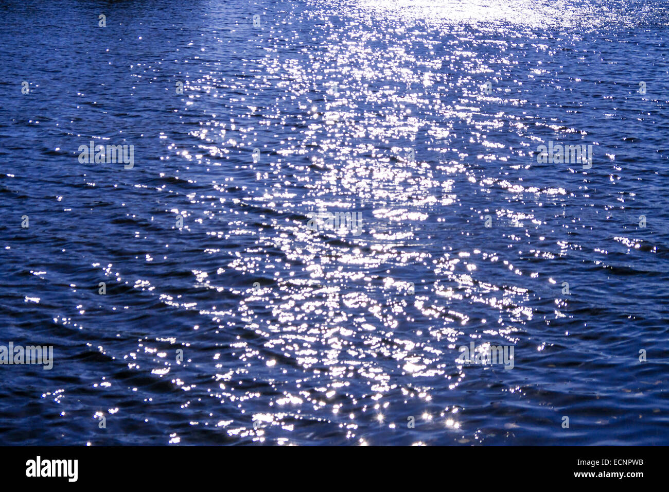 Sunreflections auf dunkelblaue Wasser Stockfoto
