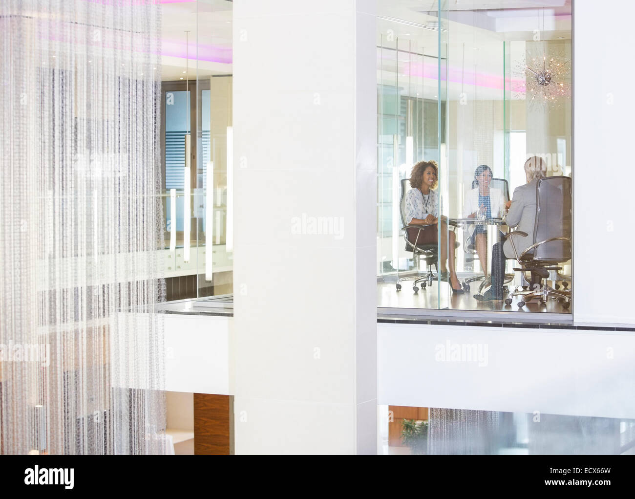 Business-Leute sitzen im Konferenzraum, Lächeln und reden Stockfoto