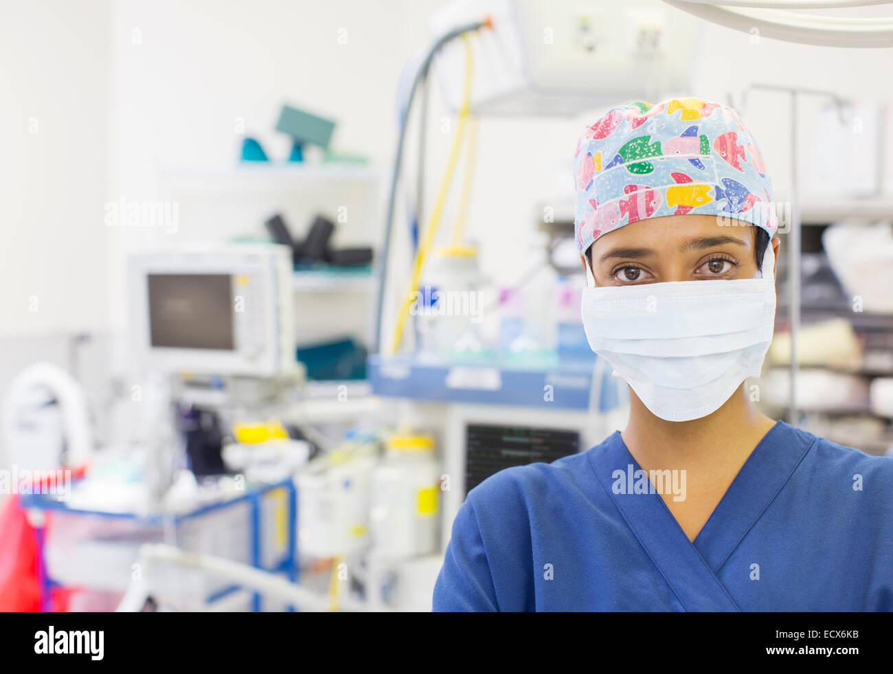 Porträt von Krankenschwester tragen bunte OP-Cap und Maske im Operationssaal Stockfoto