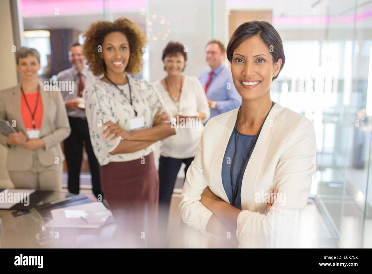 Porträt von zuversichtlich Geschäftsfrau mit Kollegen im Hintergrund im Konferenzraum Stockfoto