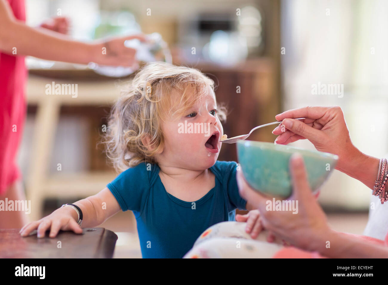 Mutter Fütterung Baby Sohn aus Schüssel Stockfoto