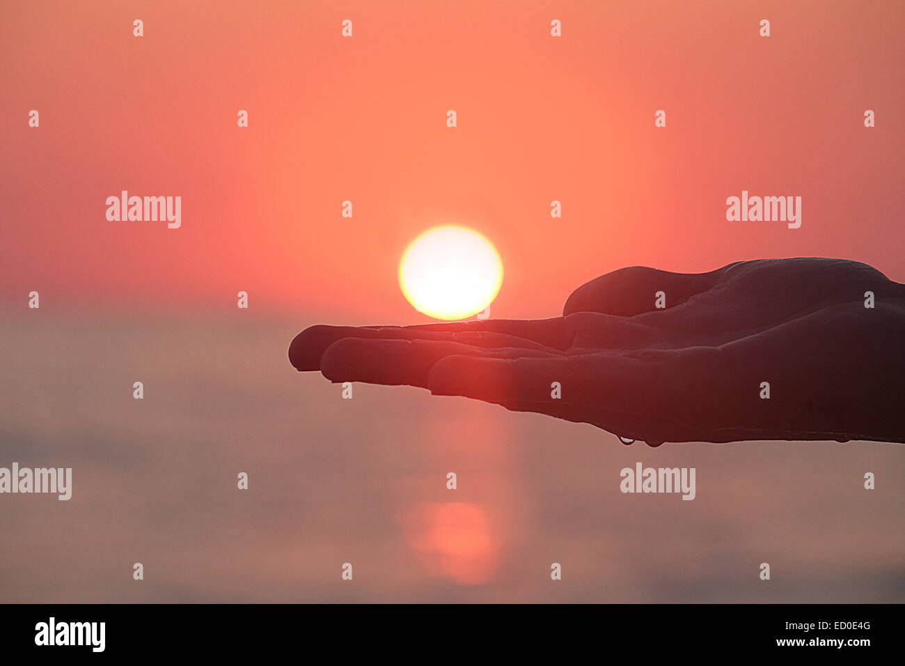 Griechenland, Person Hand gegen die Sonne bei Sonnenuntergang Stockfoto