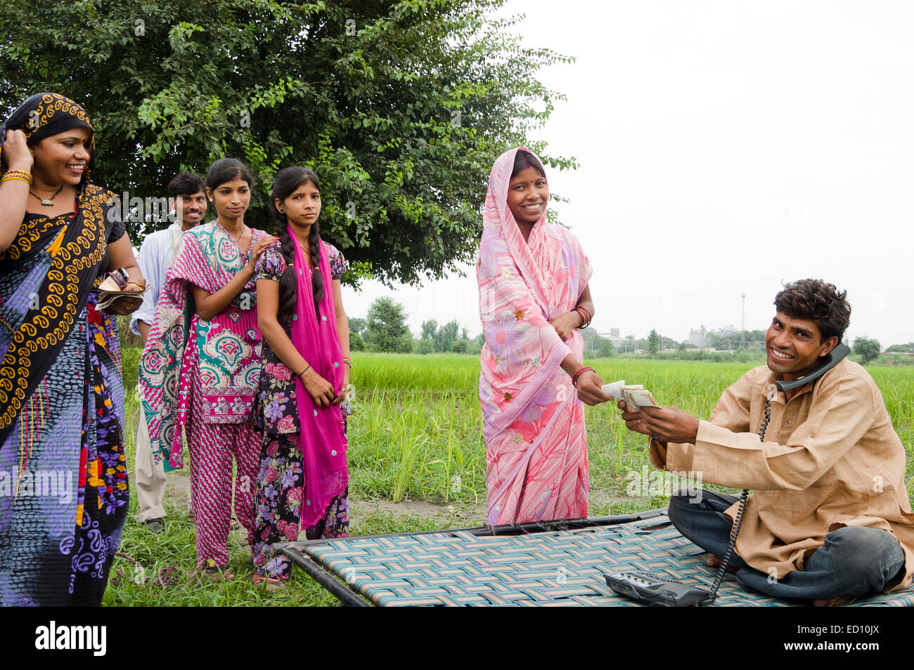 1 indischen ländlichen Bauern sprechen Telefon und Arbeit Geld geben Stockfoto